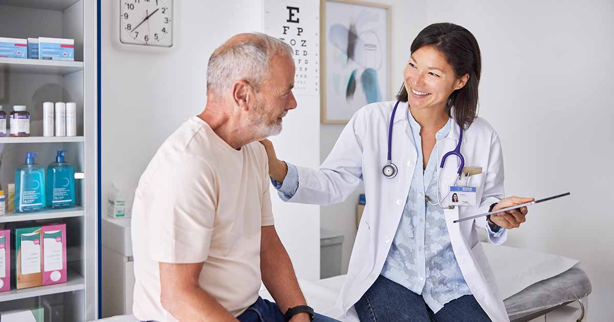 Doctor with tablet talking to patient