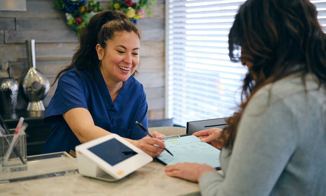 Person signing form at medical office