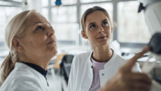 Clinicians consulting an AI display