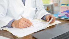 Physician filling out form