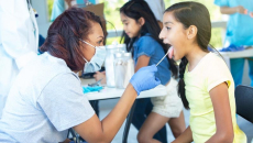 Clinician helping a child at a clinic.