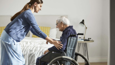 Home health worker helping a man in a wheelchair