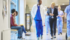 Clinicians walking down a hospital corridor