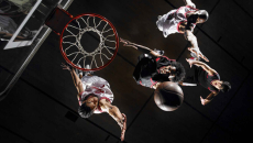Basketball players driving toward the hoop