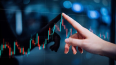 Hand pointing to a line graph