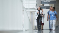 Clinicians walking down hospital corridor