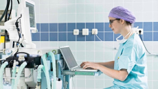Clinician typing at a computer