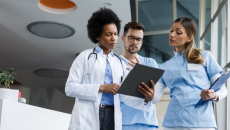 Clinicians huddled around a clipboard