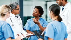 Clinicians talking in a hospital corridor