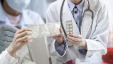 Clinicians exchanging pill packets