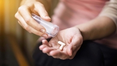 Woman pours pills into her hand