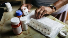Senior woman sorting drugs