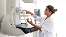 Clinician preparing mammography machine