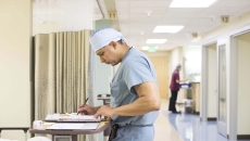 Surgeon looking at notes