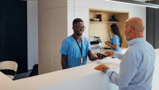 Person paying healthcare worker with credit card