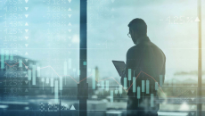 Business person using tablet over shifting stock market image