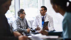 Doctor talks with patient on a couch
