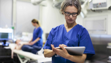 Physician uses tablet for information.