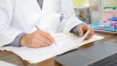 Physician filling out form