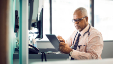Doctor looking at computer tablet