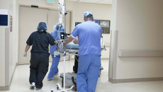 Hospital staff wheeling a patient