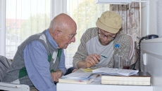 Two people go over insurance forms
