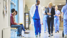 Physician walking down hospital hallway