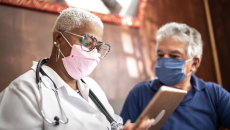 Doctor with tablet and patient