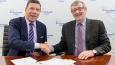 From left, John M. Murphy, MD, president and CEO of Nuvance Health, shakes hands with Northwell president and CEO Michael Dowling at a signing ceremony.