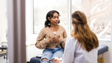 A patient talks with her doctor in the office.