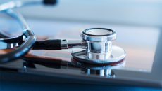 A stethoscope resting on a tablet