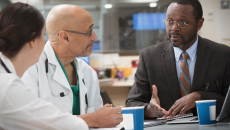 Doctors meet with man in suit
