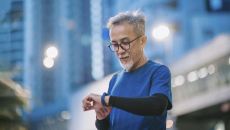 Person outside looking at fitness band