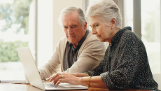 A senior couple searches online for a Medicare Advantage plan