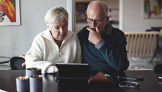 Senior couple searching on their computer.