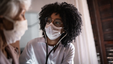 Doctor examines patient in office