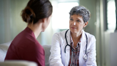 Doctor with patient in exam room
