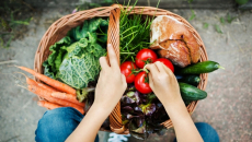 Hands sorting through fruits and vegetables