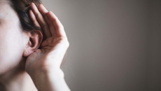 Person cupping an ear