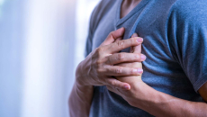 Hands clutching chest