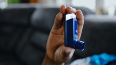Hand holding asthma inhaler