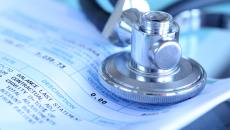 Stethoscope resting on papers