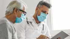 Medical professional with elderly patient