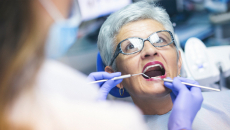Dentist treating older patient