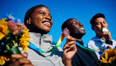 Olympic athletes smiling on winners' podium