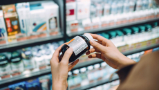 Hands hold pill bottle at drug store