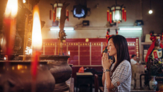 Person praying in religious setting