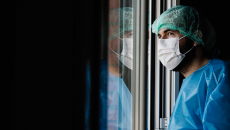 Healthcare professional at window