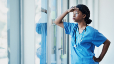 Sad health professional at window