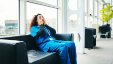 Medical professional exhausted on a hospital couch